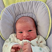 Eden participe au concours pour gagner de l'argent avec cette photo : baby, infant, face, clothing, onesie, cushion, soft, newborn, portrait, hands, cute, cozy, indoor, child, person, head, expression, comfort, sleepwear, bundle