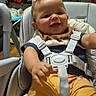 Dailier joined the competition — help win amazing prizes! baby, blanket, child, clothing, couch, cute, furniture, happy, high_chair, home, indoor, infant, living_room, person, playful, seatbelt, seated, smiling, toy, yellow_pants