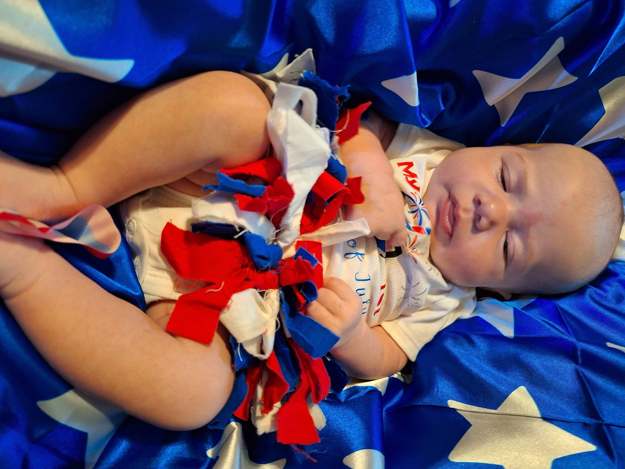 Dawn is registered to the contest to win money with this photo: azure, baby, baby_toddler_clothing, blue, child, electric_blue, event, fun, gesture, hand, happy, hat, human_body, human_leg, leisure, mouth, nail, person, red, thigh