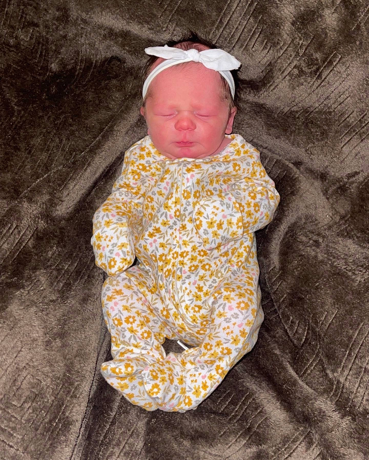 Lakelynn is registered to the contest to win money with this photo: baby, baby_products, baby_toddler_clothing, beanie, cap, child, costume, hat, head, linens, outerwear, pattern, person, personal_protective_equipment, sitting, sleeve, sunglasses, t_shirt, toddler, tree