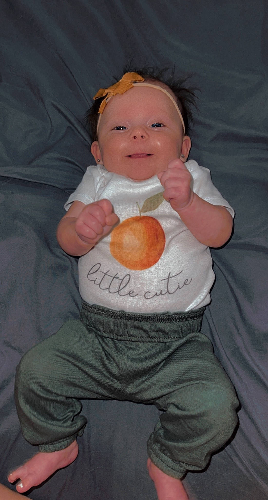 Lakelynn is registered to the contest to win money with this photo: arm, baby, cheek, comfort, eye, face, facial_expression, finger, gesture, hairstyle, hand, head, joint, mouth, nose, organ, person, sleeve, smile, stomach