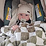 Leelynd is registered to the contest to win money with this photo: baby, infant, pacifier, knit_hat, blanket, checkered_blanket, car_seat, warning_label, hand, face, eyes, cute, indoors, cozy, bedding, hood, seat, portrait, soft_texture, winter_clothing