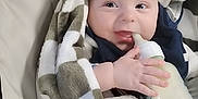 Leelynd is registered to the contest to win money with this photo: baby, blanket, bottle, child, cozy, cute, feeding, happy, indoors, infant, milk, person, portrait, seat, smile, soft, toddler, warm, wrapped, young