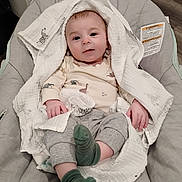 Leelynd joined the competition — help win amazing prizes! baby, blanket, baby_chair, cushion, infant, child, smiling, face, clothing, socks, cute, indoor, portrait, dinosaur_print, toddler, cozy, comfort, hands, feet, relaxed