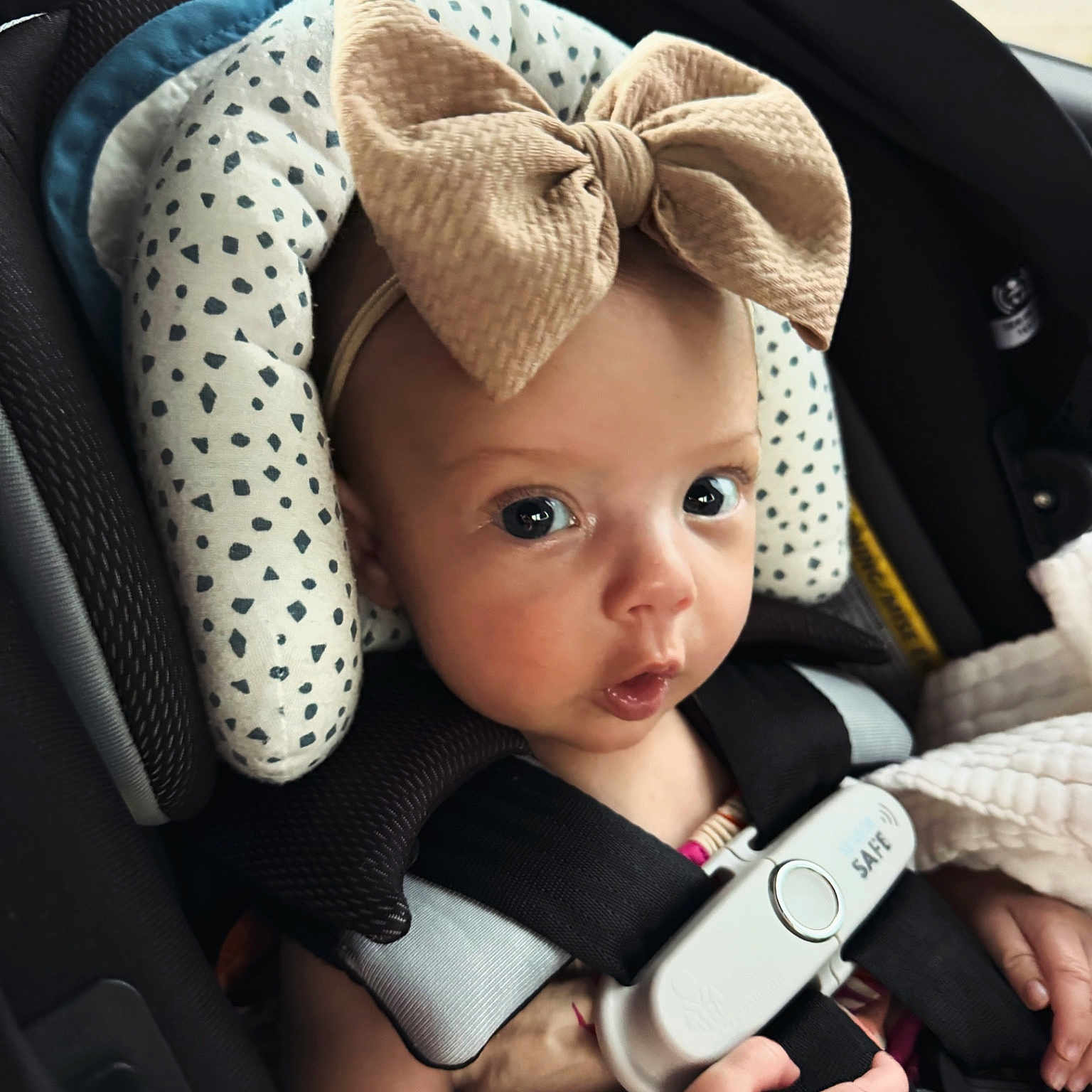 Aubree is registered to the contest to win money with this photo: baby, bodypart, car, car_interior, carseat, clothing, cushion, face, finger, hand, happy, hat, head, homedecor, person, photography, portrait, transportation, vehicle, vrheadset