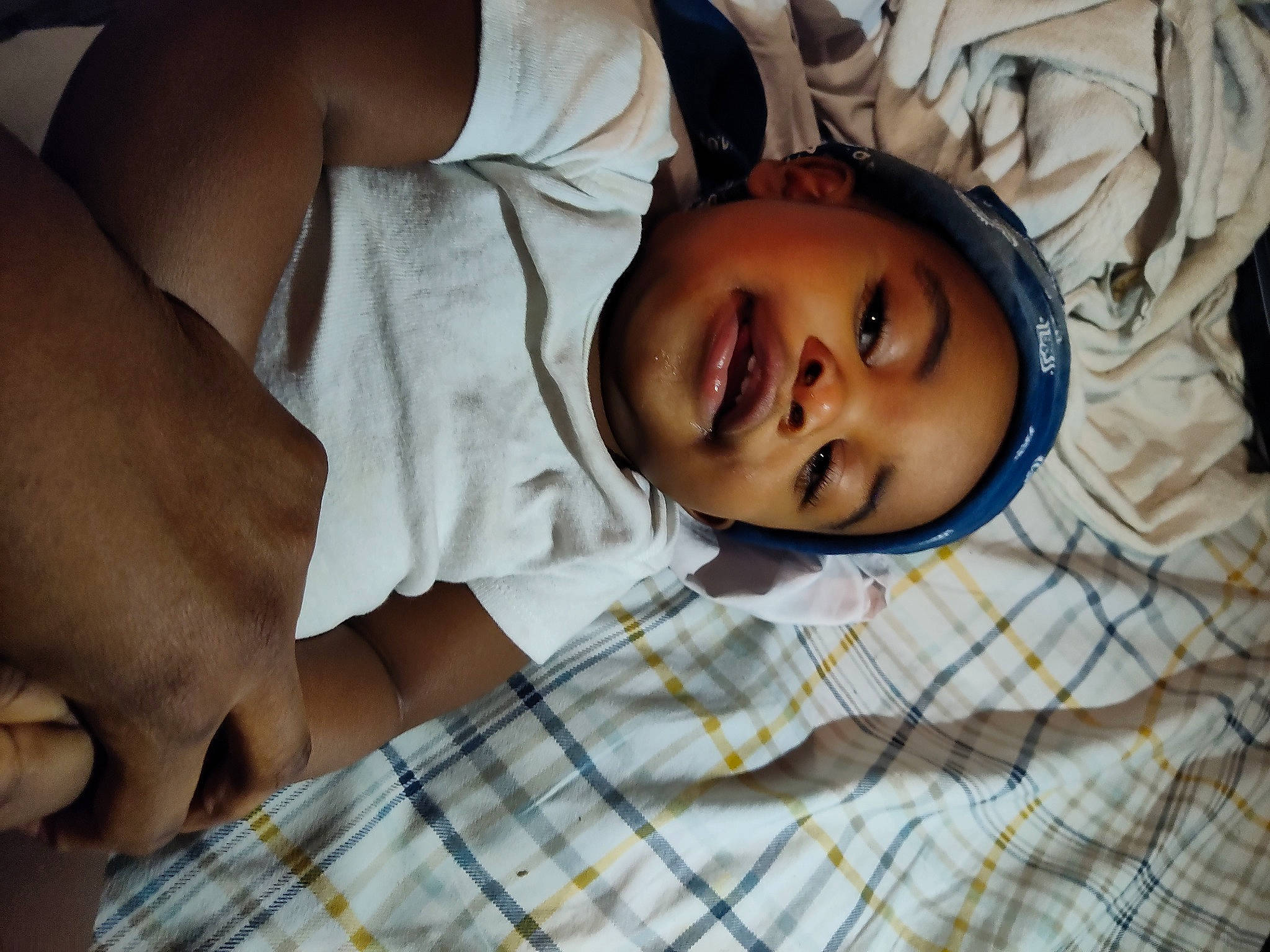 Jalen is registered to the contest to win money with this photo: bedtime, child, comfort, eye, eyelash, fun, happy, head, linens, mouth, nose, pattern, people, person, plaid, skin, sleep, sleeve, smile, tartan