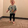 toddler, child, blonde_hair, standing, indoor, carpet, step, green_shirt, leggings, barefoot, wall, room, portrait, young_child, casual_clothing, smiling, hair, person, cute, small