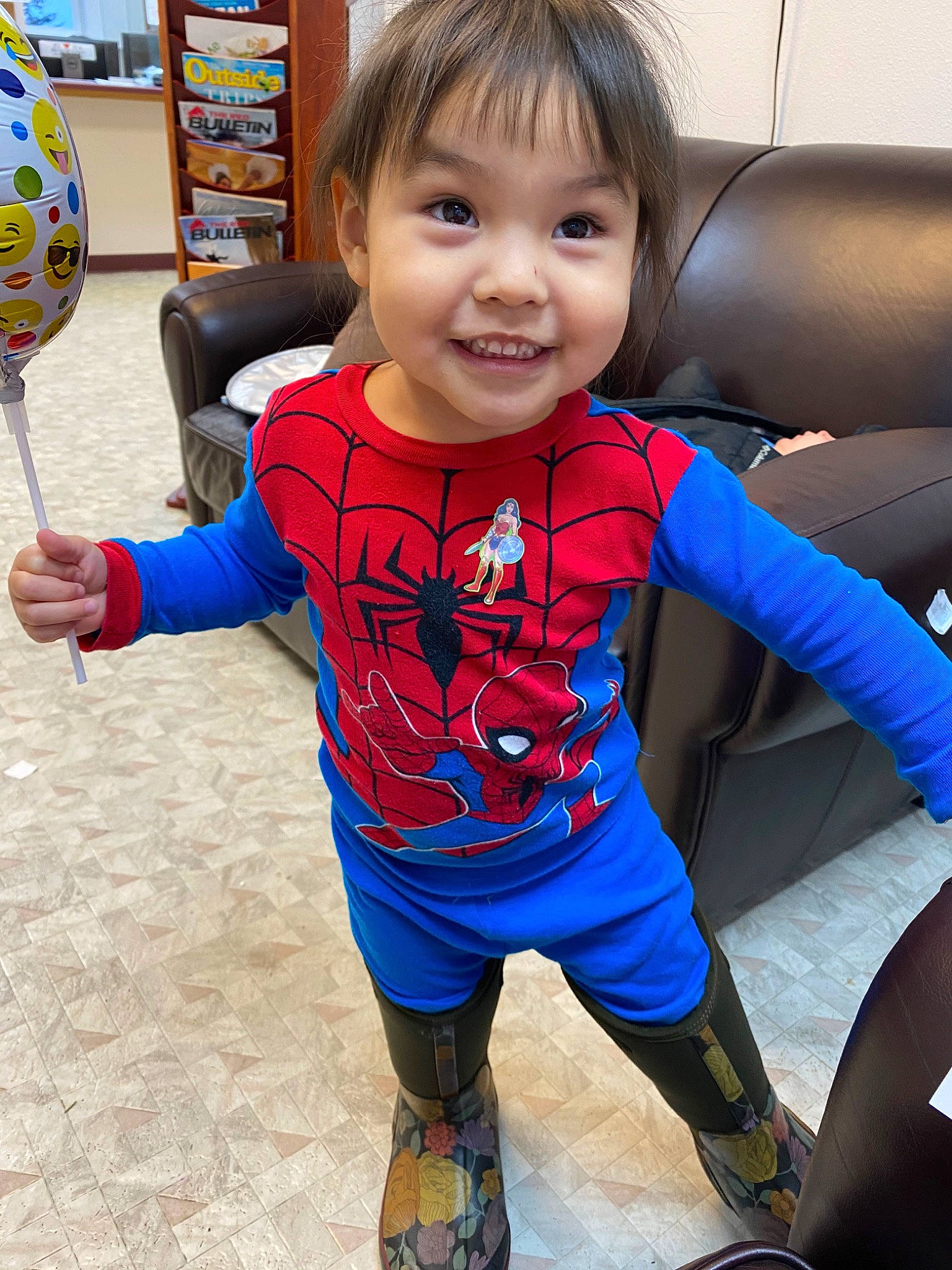 Zipporah is registered to the contest to win money with this photo: arm, baby, blue, child, electric_blue, face, fictional_character, joy, outerwear, person, personal_protective_equipment, play, skin, sleeve, smile, standing, superhero, t_shirt, toddler, vacation