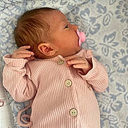Cassandra participe au concours pour gagner de l'argent avec cette photo : baby, newborn, infant, pacifier, pink_clothing, ribbed_fabric, buttoned_onesie, lying_down, blanket, patterned_blanket, soft_texture, sleepy, cute, newborn_baby, infant_face, small_hands, baby_clothes, indoors, resting, calm