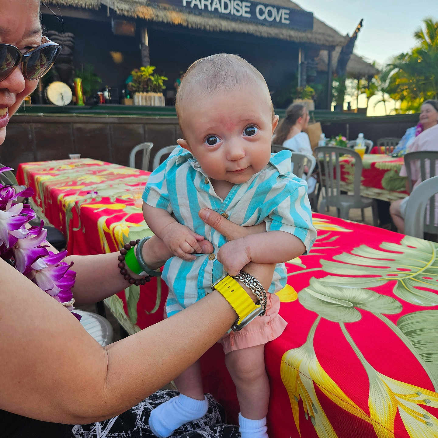 Desmond is registered to the contest to win money with this photo: accessories, adult, architecture, baby, building, clothing, dress, face, female, flower, flowerarrangement, head, outdoors, person, photography, plant, portrait, pottedplant, shelter, woman