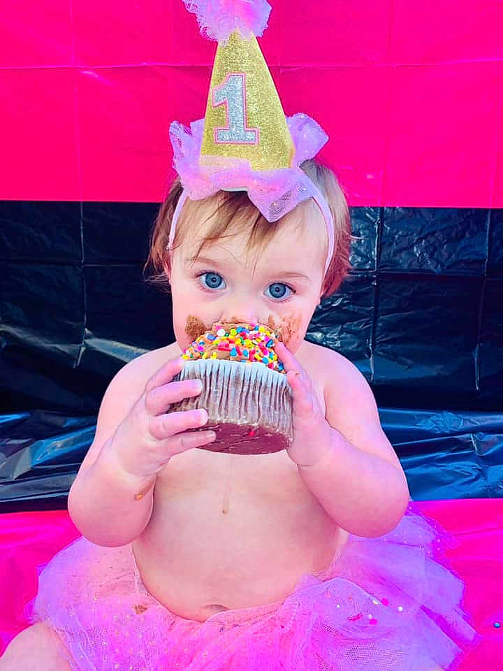 Sage is registered to the contest to win money with this photo: baby, birthdaycake, birthdayparty, cake, clothing, cream, dessert, eating, face, food, fun, hat, head, icing, party, people, person, photography, portrait, sweets