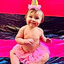 Sage is registered to the contest to win money with this photo: baby, bodypart, clothing, costume, cream, dessert, dress, face, finger, food, hand, hat, head, icecream, partyhat, person, photography, portrait, purple, sitting