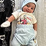 baby, smiling, infant, mickey_mouse, hat, mittens, blue_pants, white_shirt, cartoon_characters, blanket, lying_down, cute, happy, footwear, soft_toys, patterned_blanket, child, indoors, portrait, clothing