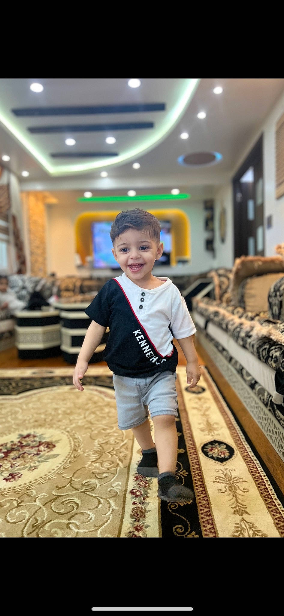 Amir is registered to the contest to win money with this photo: child, fashion_design, floor, flooring, fun, happy, hardwood, houseplant, joy, leisure, pattern, person, room, shorts, sleeve, smile, t_shirt, toddler, wood