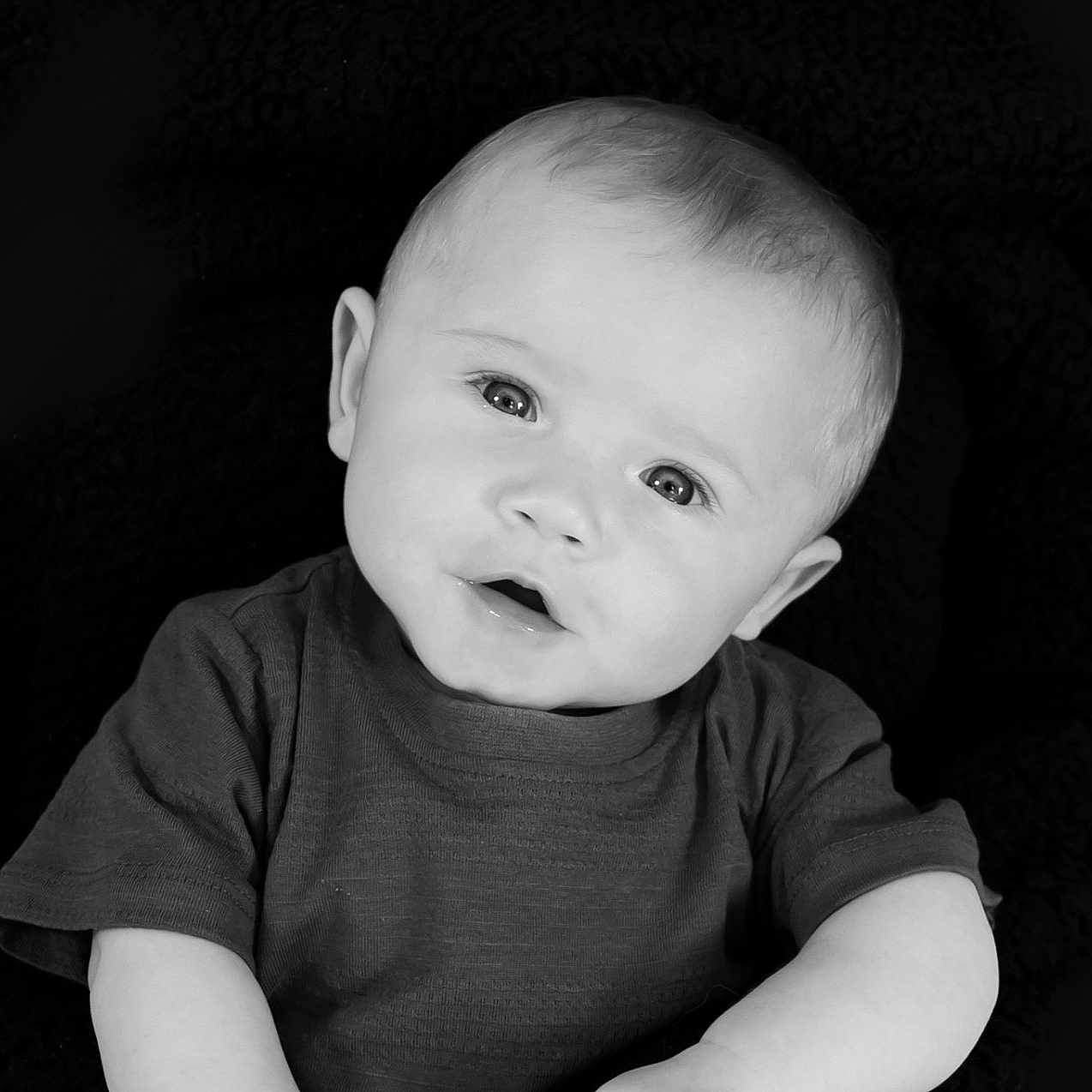 Arlow Macdonald is registered to the contest to win money with this photo: baby, black_and_white, child, clothing, cute, expression, eyes, face, head_tilt, infant, monochrome, person, photography, portrait, short_sleeve, sitting, skin, soft_background, studio, young