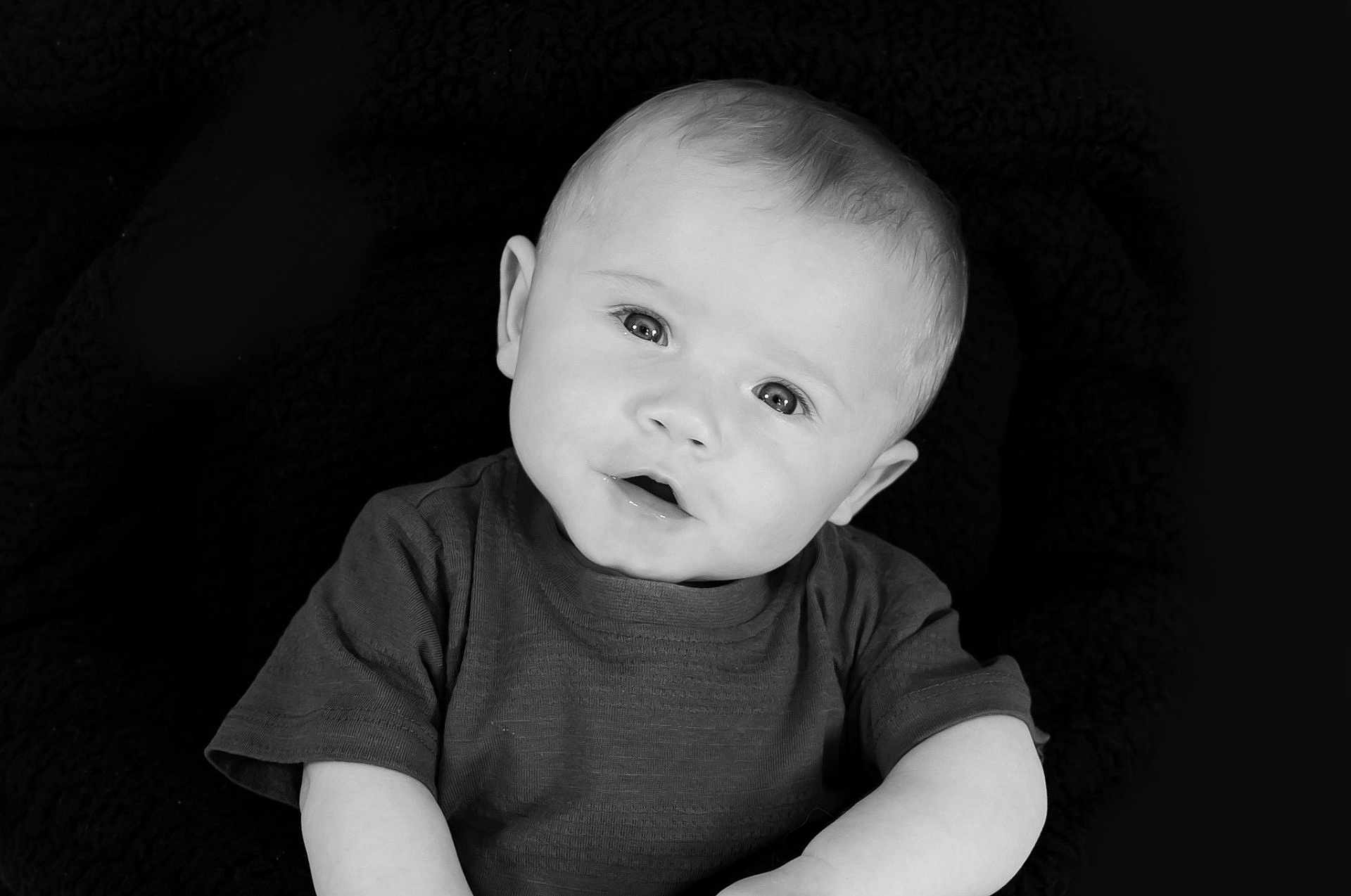 Arlow Macdonald is registered to the contest to win money with this photo: baby, child, portrait, black_and_white, infant, face, eyes, expression, cute, head_tilt, young, person, sitting, clothing, monochrome, soft_background, short_sleeve, skin, photography, studio