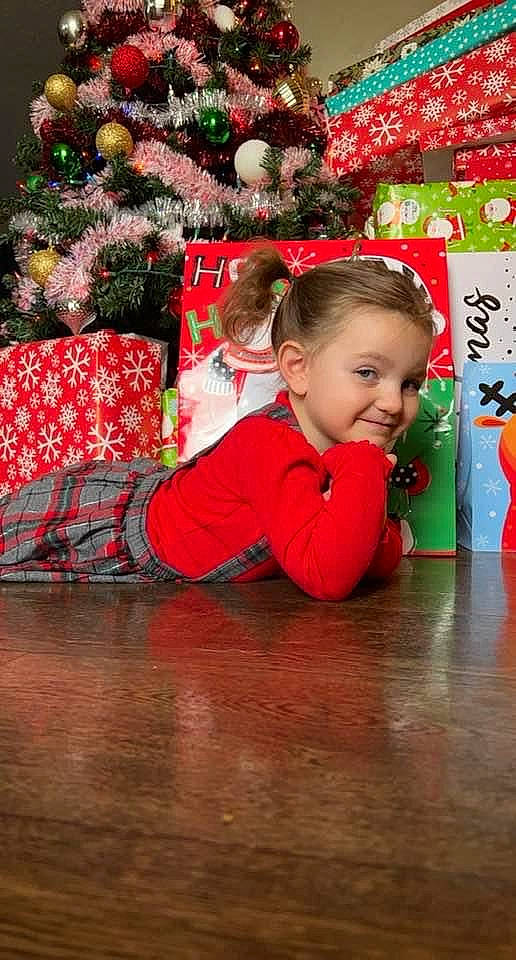 Ariya joined the competition — help win amazing prizes! child, christmas, christmas_decoration, christmas_eve, christmas_ornament, christmas_tree, conifer, event, flooring, fun, happy, holiday, holiday_ornament, joy, leisure, ornament, person, red, smile, toddler