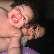 Kai joined the competition — help win amazing prizes! toddler, child, woman, smile, happy, face, portrait, curly_hair, skin, person, intimate, closeup, selfie, light, dark_background, bedroom, cozy, family, emotion, affection