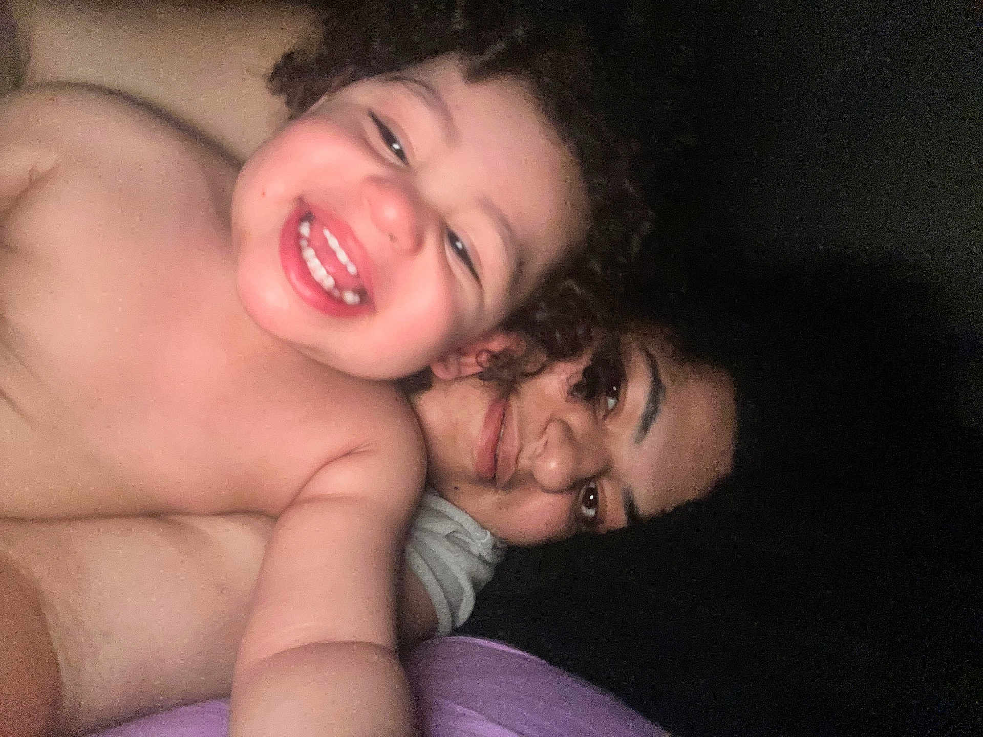 Kai joined the competition — help win amazing prizes! toddler, child, woman, smile, happy, face, portrait, curly_hair, skin, person, intimate, closeup, selfie, light, dark_background, bedroom, cozy, family, emotion, affection