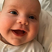 Layla-Rae joined the competition — help win amazing prizes! baby, blanket, cheeks, child, close_up, cute, expression, eyes, face, happy, head, indoors, infant, mouth, onesie, portrait, skin, smiling, soft_light, white_clothing