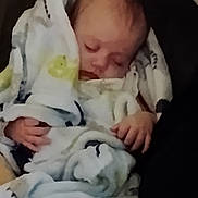 Alaina is registered to the contest to win money with this photo: baby, blanket, sleeping, infant, cozy, soft, wrapped, hands, face, peaceful, comfort, child, cute, resting, indoors, warm, head, small, portrait, young