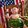 baby, child, watermelon, wooden_chair, american_flag, stars, outdoor, summer, cute, funny_expression, fruit_costume, patriotic, green, red, blue, wood, skin, face, sitting, holiday