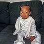 Kyleigha is registered to the contest to win money with this photo: baby, child, clothing, couch, cozy, cute, earrings, fashion, footwear, happy, hoodie, indoor, infant, pant, person, portrait, sitting, smile, sneakers, white_shoes