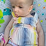 arm, baby, baby_seat, child, circles, colorful, cute, expression, frog_design, hand, head, indoors, infant, patterned_background, romper, sitting, skin, striped_clothing, tongue_out, young_child