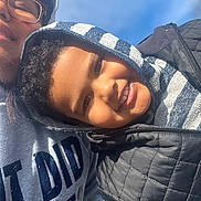 Jeremiah joined the competition — help win amazing prizes! adult, blue_sky, casual_clothing, child, closeup, daytime, face, family, glasses, happy, headwear, hoodie, jacket, outdoor, person, portrait, smiling, sunlight, together, winter_wear