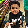 Jeremiah joined the competition — help win amazing prizes! black_hair, casual_clothing, child, colorful_wall, floor, food, footwear, happy, holding, ice_cream, indoor, jacket, person, playful, portrait, railing, smiling, snack, tshirt, wood_panel
