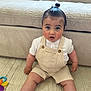 Kaylan participe au concours pour gagner de l'argent avec cette photo : baby, child, infant, topknot, overalls, white_socks, carpet, couch, toy, beige, striped, curious, sitting, indoors, portrait, cute, person, young_child, expression, furniture