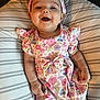 Sophia is registered to the contest to win money with this photo: baby, bed, bonnet, clothing, couch, cushion, dress, face, furniture, happy, hat, head, homedecor, newborn, person, photography, portrait, sleeve, smile, t_shirt