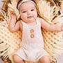 accessories, baby, basket, bonnet, clothing, crib, face, furniture, hat, head, infantbed, jewelry, necklace, newborn, person, photography, portrait, sleeping, text, toy