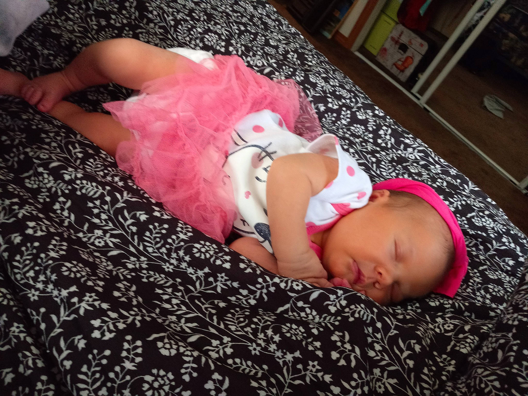 Addelyn is registered to the contest to win money with this photo: baby, baby_toddler_clothing, comfort, finger, flesh, flooring, foot, fun, hand, head, human_body, human_leg, lap, linens, magenta, nap, person, pink, room, thigh