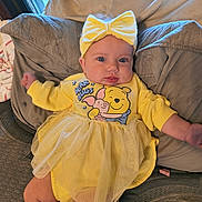 Ariel joined the competition — help win amazing prizes! baby, yellow, headband, bow, couch, cushion, infant, child, tutu, dress, winnie_the_pooh, bear_hugs, blue_eyes, indoor, portrait, cute, smiling, plush, window, relaxed
