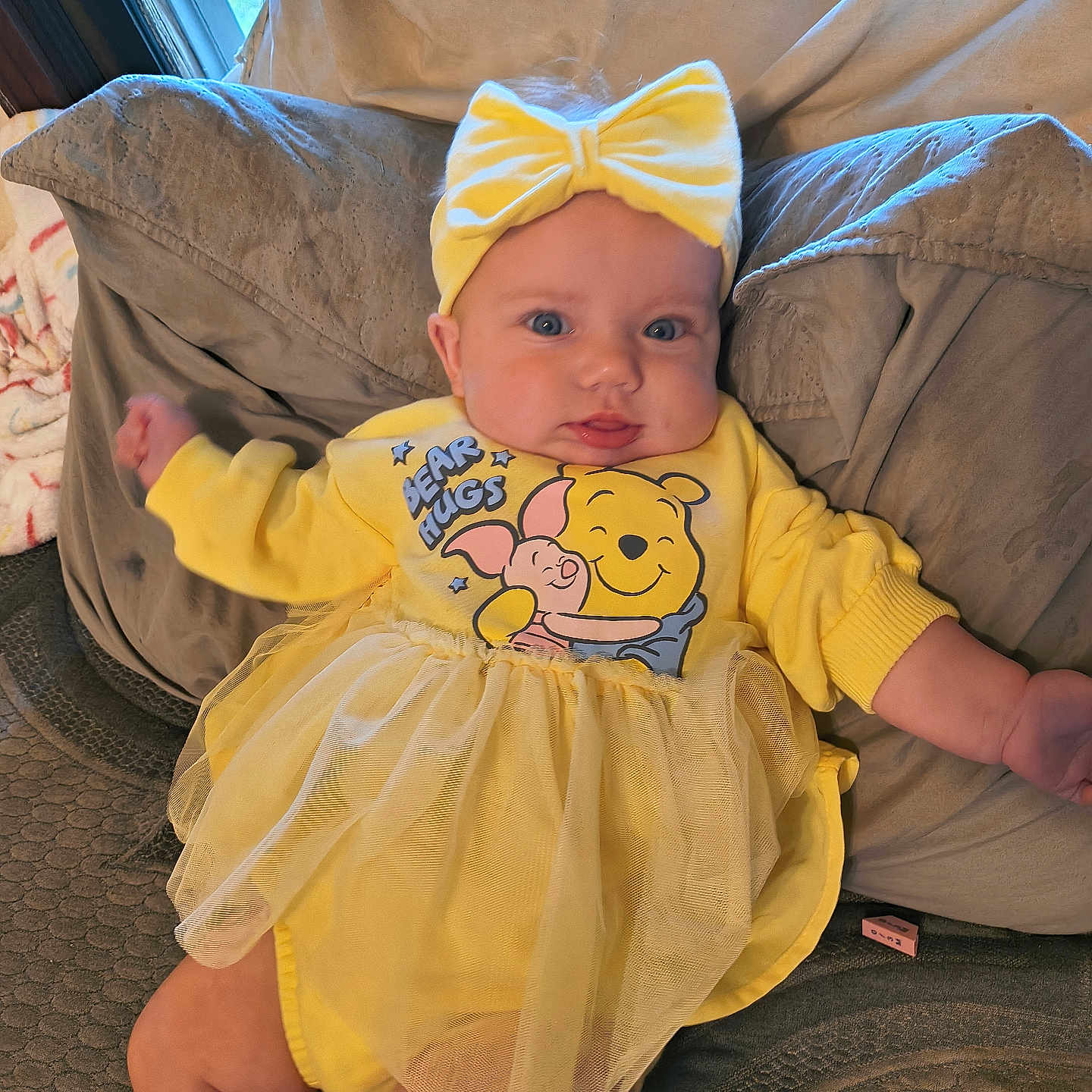 Ariel joined the competition — help win amazing prizes! baby, bear_hugs, blue_eyes, bow, child, couch, cushion, cute, dress, headband, indoor, infant, plush, portrait, relaxed, smiling, tutu, window, winnie_the_pooh, yellow