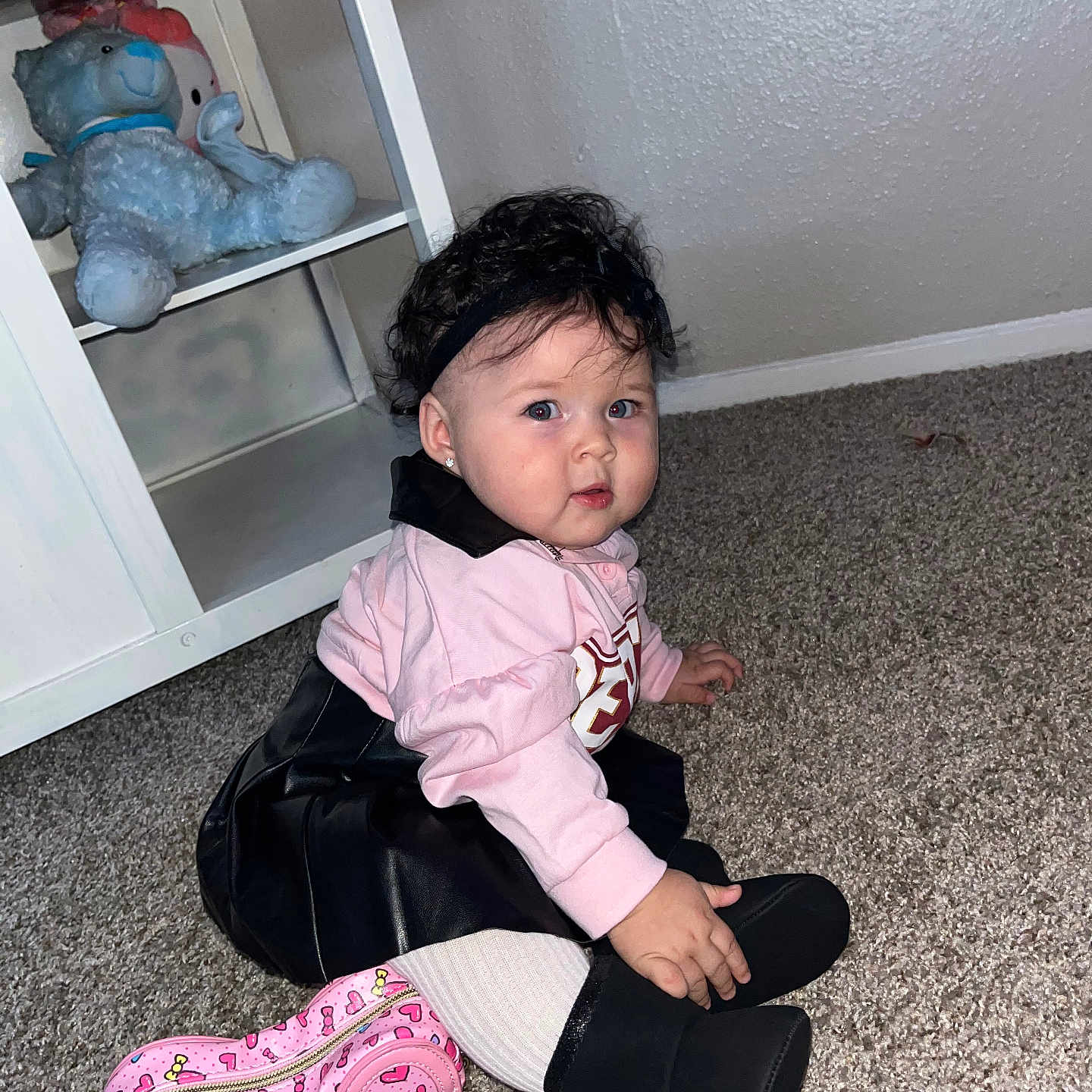 Daphne Zeinet joined the competition — help win amazing prizes! black_boots, black_skirt, carpet, child, curly_hair, cute, fashion, floor, headband, hello_kitty_purse, indoor, pink_top, portrait, shelf, sitting, stuffed_animals, toddler, toy, white_tights, young_child