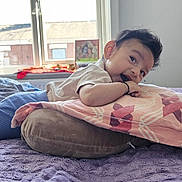 Shrivika is registered to the contest to win money with this photo: baby, bed, blanket, child, clothing, cozy, curtains, cushion, face, happy, head, indoor, light, person, pillow, purple_bedspread, resting, smile, window, young