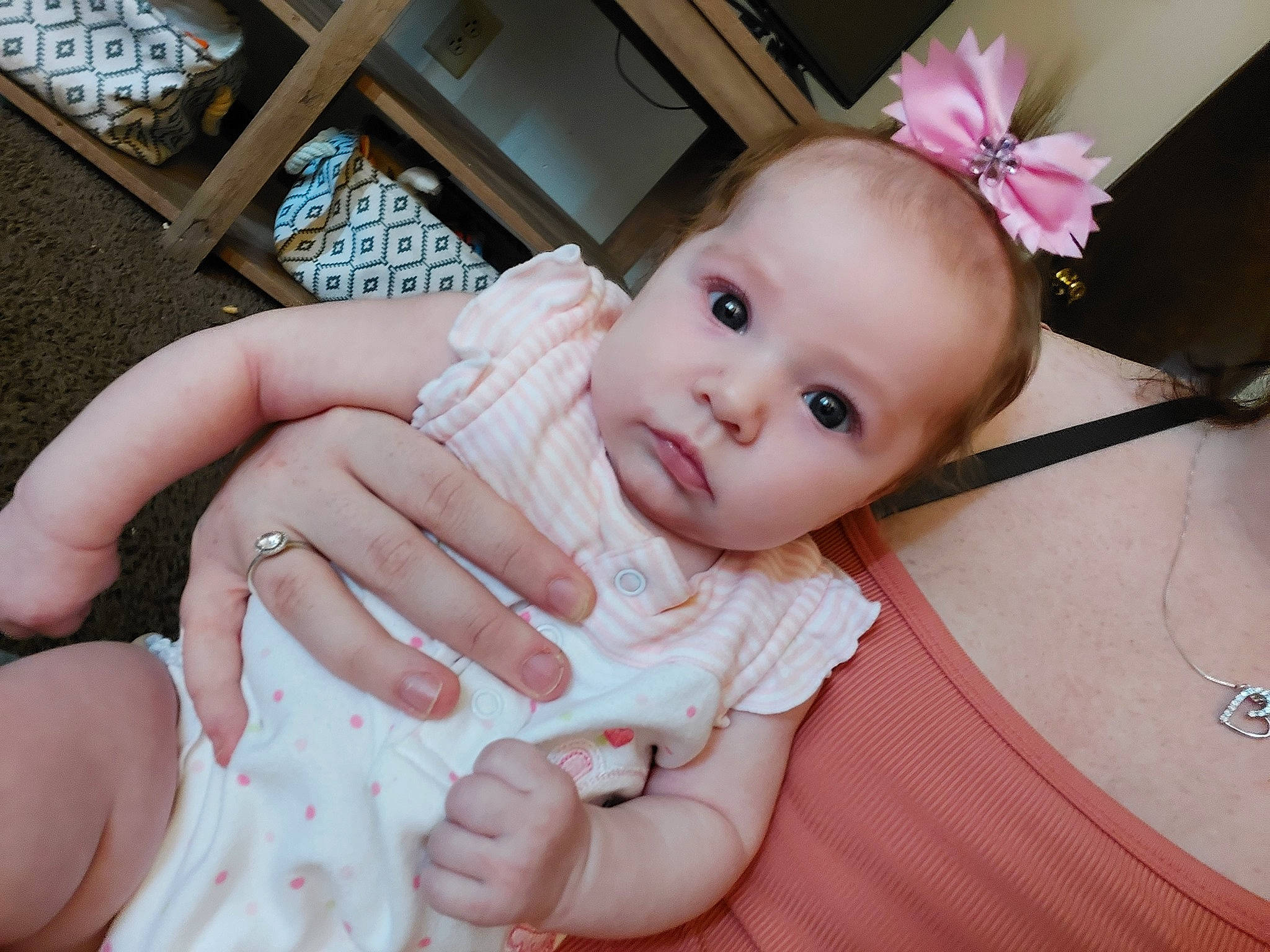 Kaydence is registered to the contest to win money with this photo: arm, baby_toddler_clothing, cheek, dress, eye, eyelash, facial_expression, finger, gesture, hand, human, human_body, iris, lip, mammal, nose, person, pink, product, skin