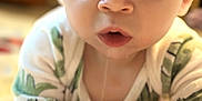 Idris joined the competition — help win amazing prizes! baby, child, drool, blue_eyes, onesie, closeup, play_mat, hand, curious, infant, face, crawling, indoor, soft_light, expression, skin, person, young, cute, portrait