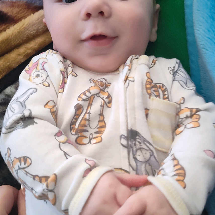 Thomas is registered to the contest to win money with this photo: applique, baby, blanket, bodypart, clothing, dress, face, finger, hand, happy, hat, head, longsleeve, newborn, pattern, person, photography, portrait, sleeve, smile