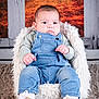 Achille participe au concours pour gagner de l'argent avec cette photo : baby, child, denim_overalls, sneakers, fluffy_chair, fur_texture, carpet, portrait, indoor, cute, serious_expression, infant, clothing, seated, studio_photo, background, warm_colors, hands, face, person
