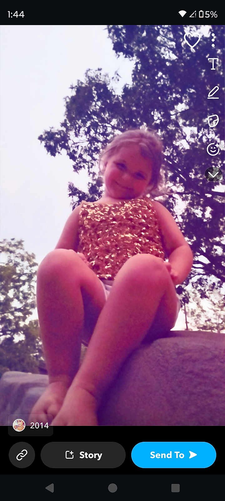 Oaklynn is registered to the contest to win money with this photo: child, girl, outdoor, nature, trees, sky, rock, smiling, sitting, sparkly_clothing, gold, barefoot, portrait, young, casual, daylight, happy, cute, playful, fun