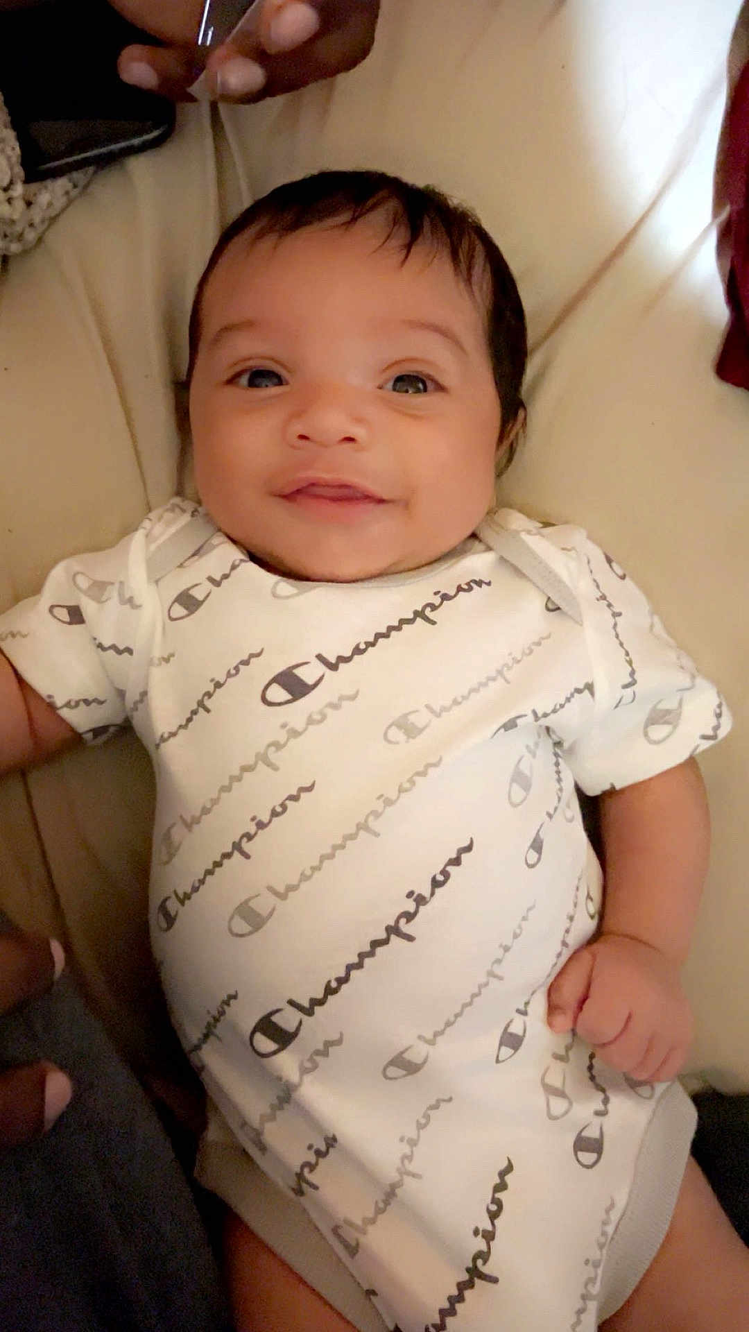Zaqurian joined the competition — help win amazing prizes! baby, infant, child, smiling, face, onesie, clothing, hand, skin, person, lying_down, indoor, bed, fabric, cute, happy, portrait, newborn, casual, comfort