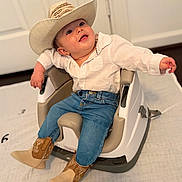 Salvador joined the competition — help win amazing prizes! baby, cowboy_hat, boots, jeans, white_shirt, baby_seat, indoor, smiling, child, cute, happy, toddler, modern_furniture, floor, door, light, pose, portrait, clothing, infant