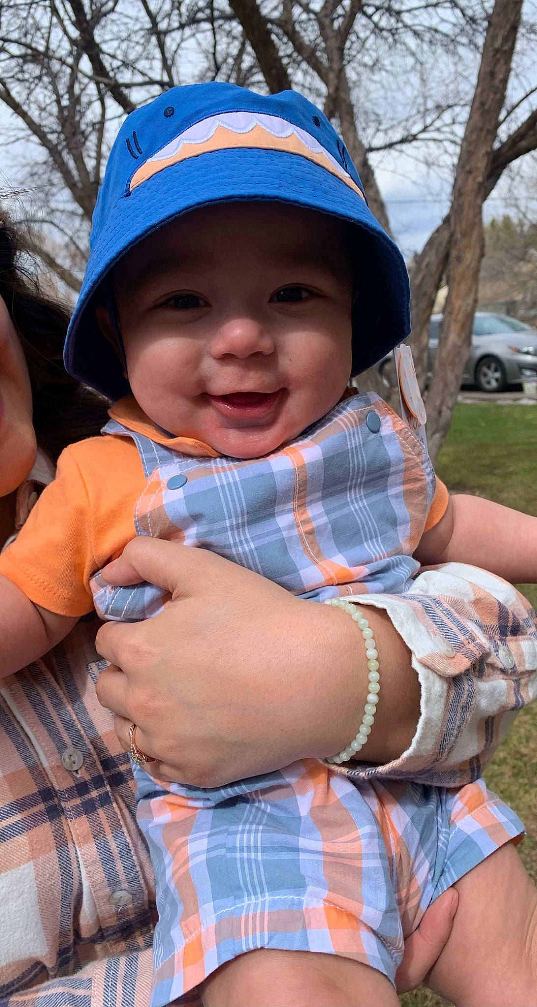 Jovanni joined the competition — help win amazing prizes! baby_toddler_clothing, baseball_cap, cap, child, electric_blue, face, fun, grass, happy, headwear, joy, leisure, pattern, people_in_nature, person, plaid, plant, recreation, skin, smile