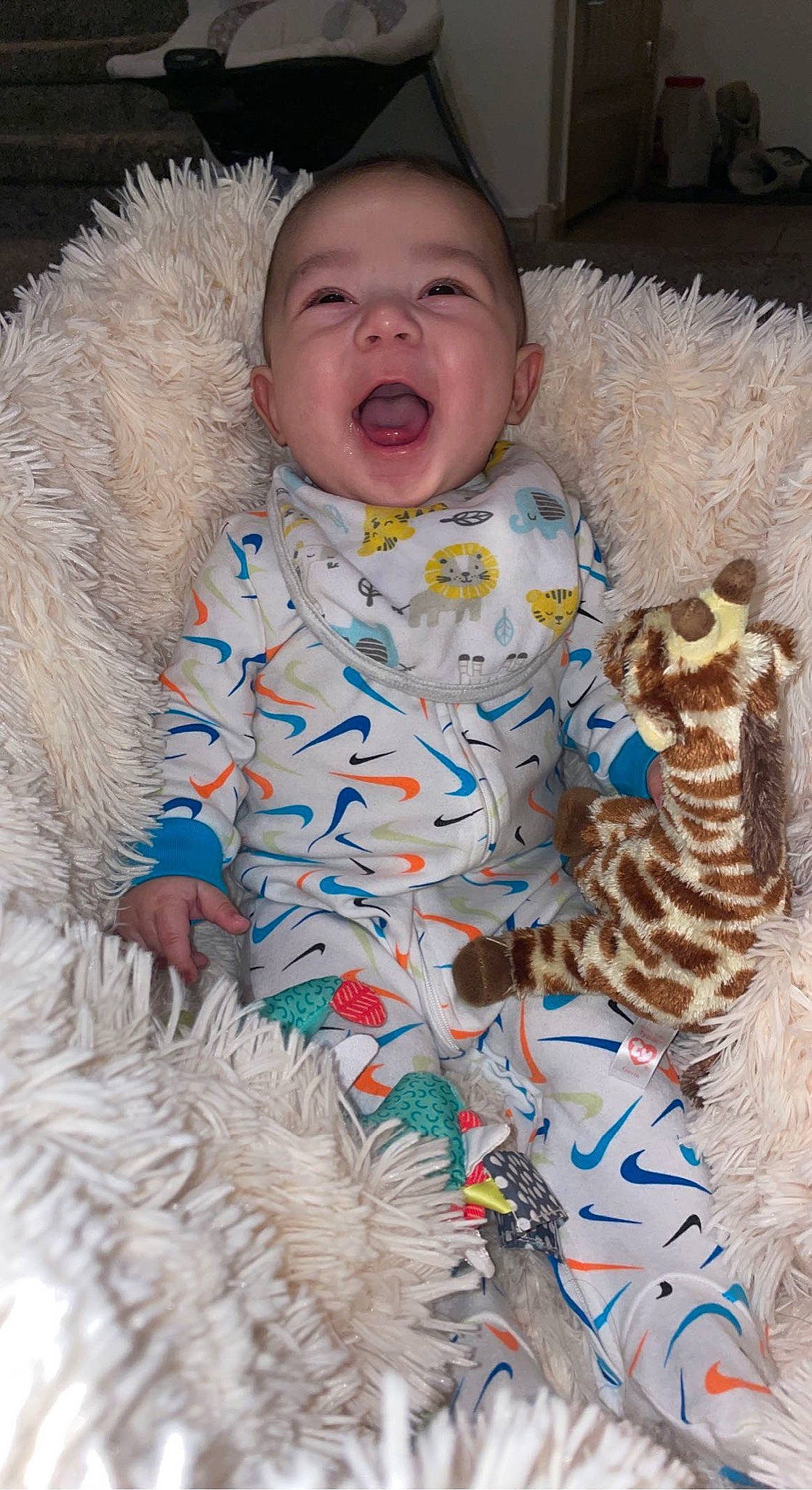 Jovanni is registered to the contest to win money with this photo: arm, baby, baby_toddler_clothing, child, clothing, comfort, eye, head, human_body, iris, mammal, nose, organ, outerwear, person, pink, skin, sleeve, textile, toddler