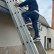 Tiziano a rejoint le concours — aidez-le/la à gagner de superbes lots ! child, ladder, climbing, outdoor, jeans, sneakers, building, sky, metal, casual_clothing, focused, residential, young, person, side_view, footwear, urban, daylight, activity, blue_jeans