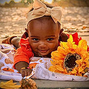 Adore is registered to the contest to win money with this photo: baby, child, smiling, headband, bow, blanket, pumpkin, sunflower, autumn, fall, outdoor, portrait, cute, happy, face, nature, seasonal, warm_light, flower, toddler