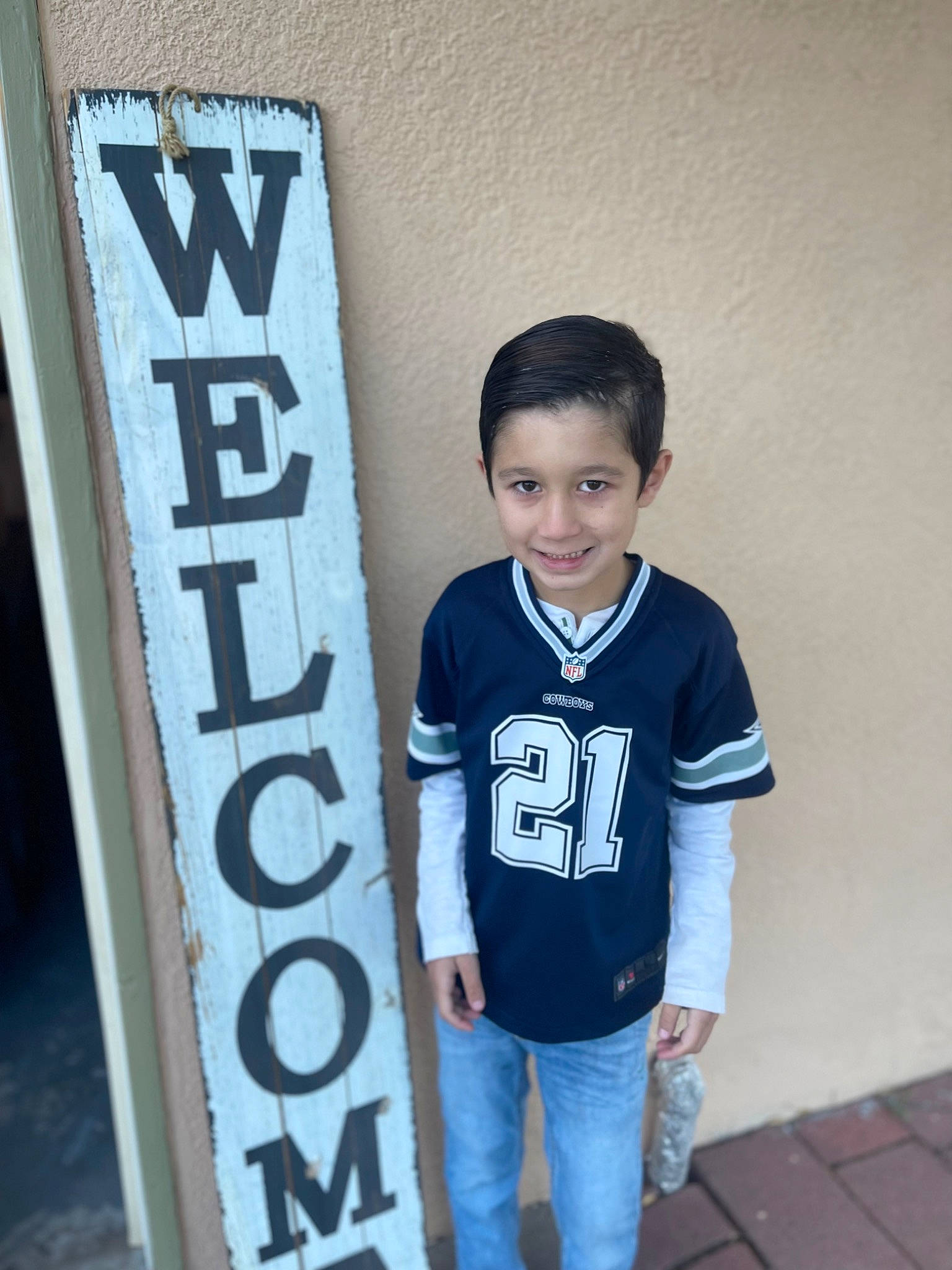 Mason is registered to the contest to win money with this photo: advertising, clothing, denim, elbow, electric_blue, flash_photography, font, fun, gas, happy, jeans, joy, person, room, sleeve, smile, t_shirt, toddler, top